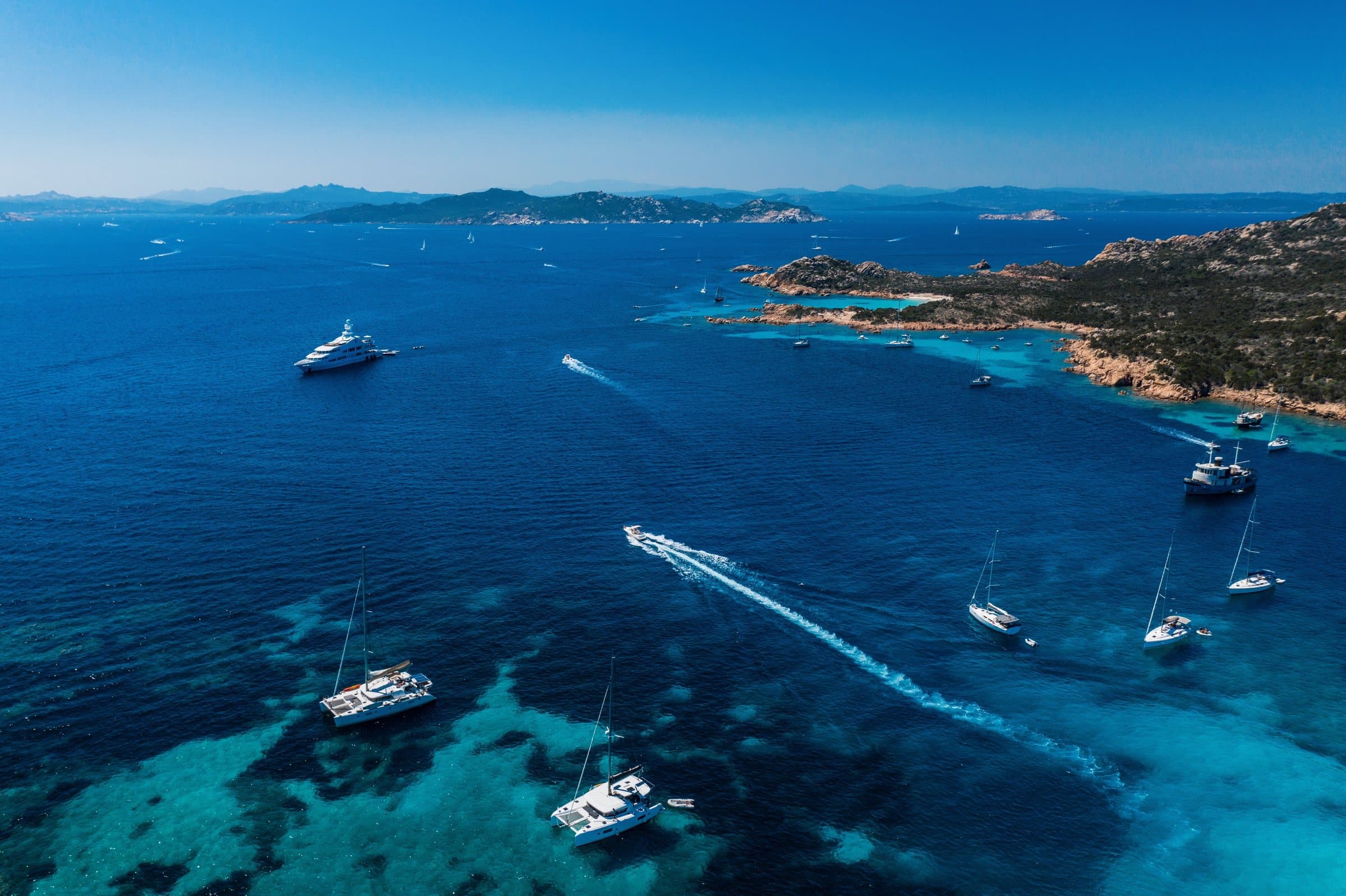 Luxury motor yacht cruising the Italian Riviera at sunset